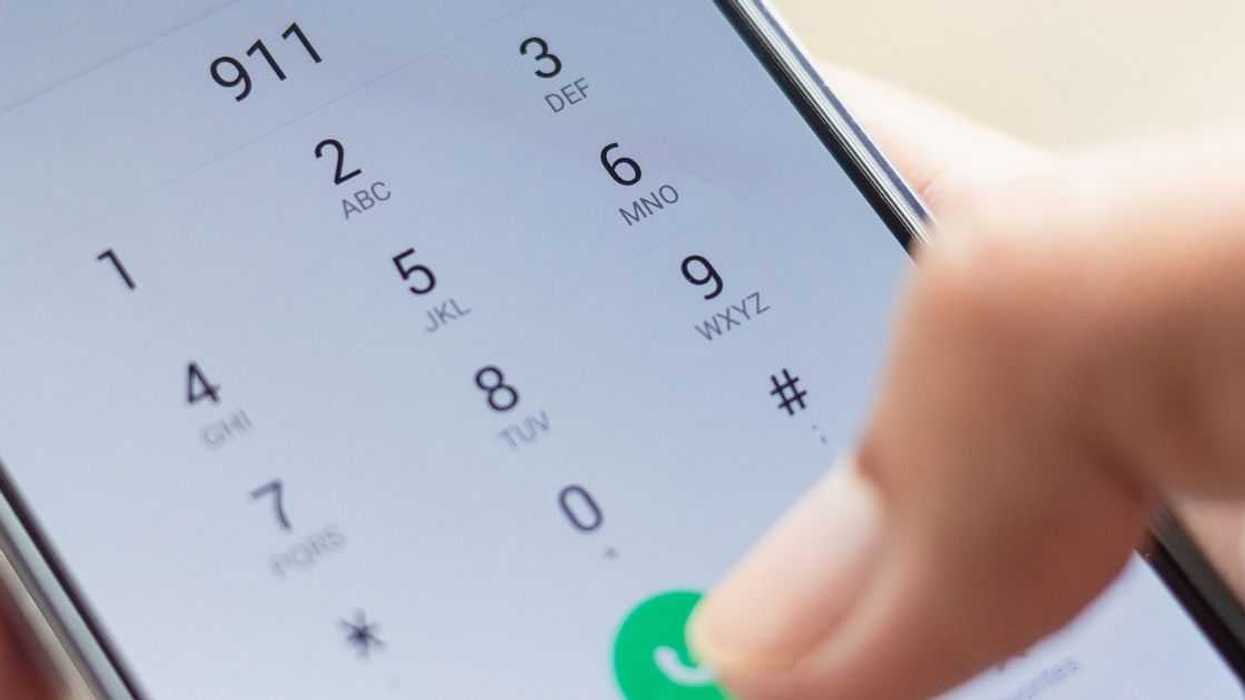Emergency and urgency, dialing 911 on smartphone screen.