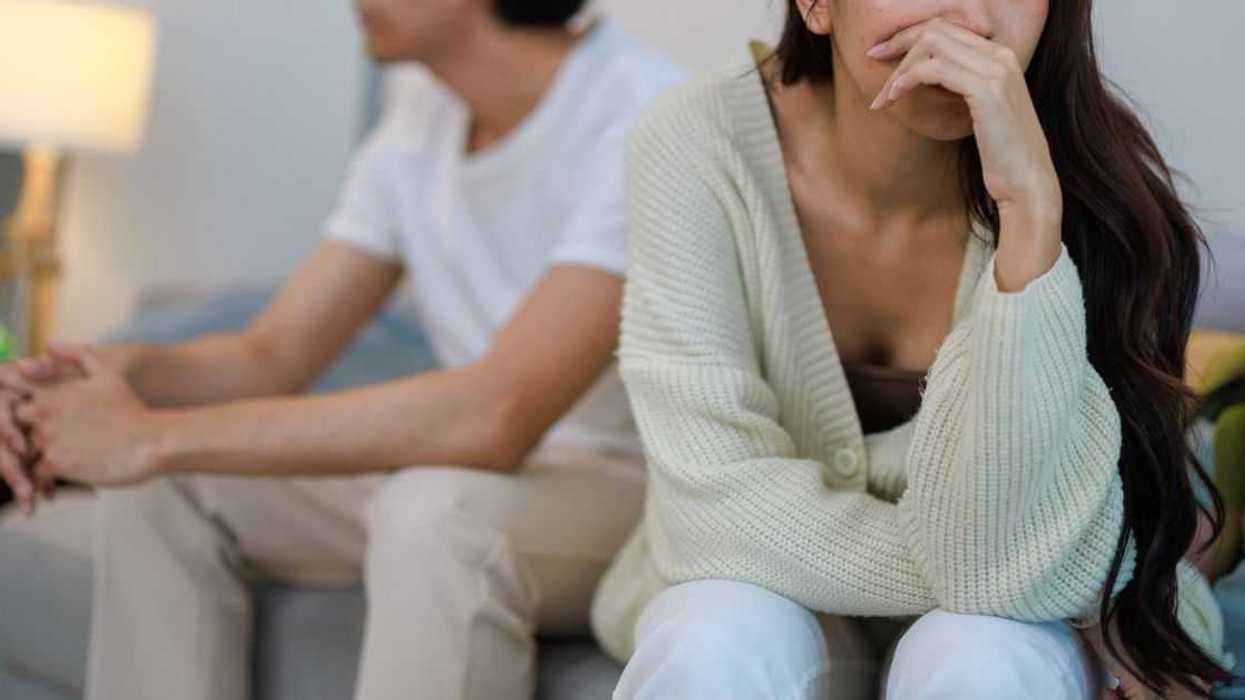 Emotional Couple Expressing Frustration and Upset in Bedroom Argument.