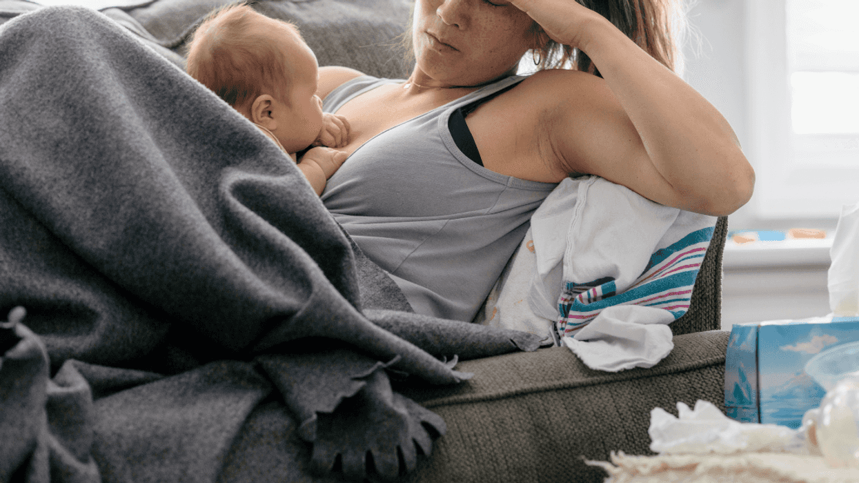 exhausted mother holding an infant