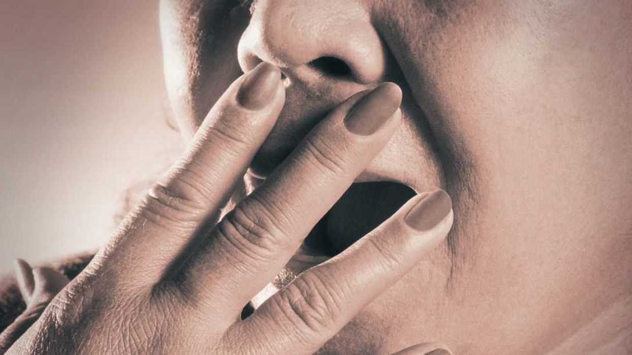 Extreme close-up of an unrecognizble woman yawning.
