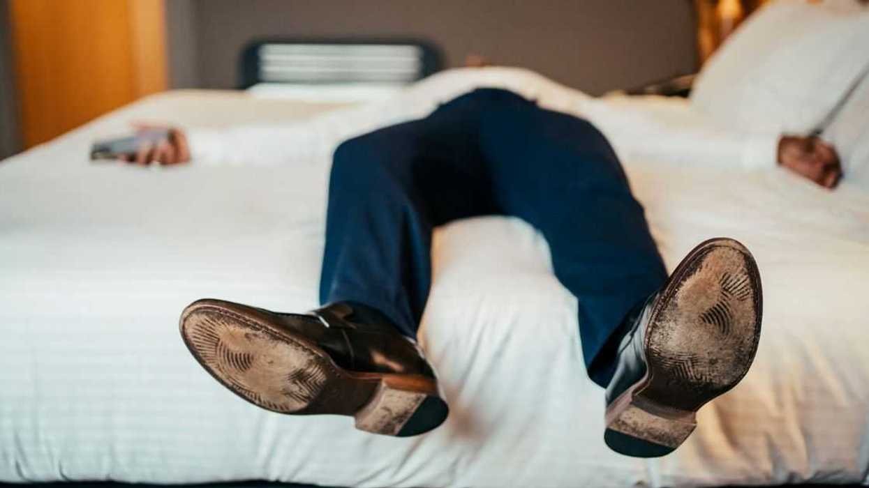 Faceless businessman resting in hotel room.