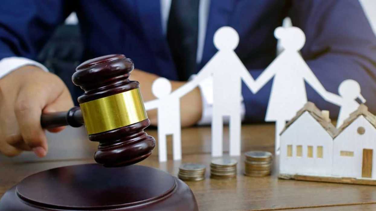 Family law concept. Cropped shot a man in a suit bringing a gavel down.