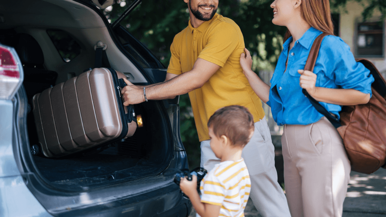 family loading luggage into vehicle