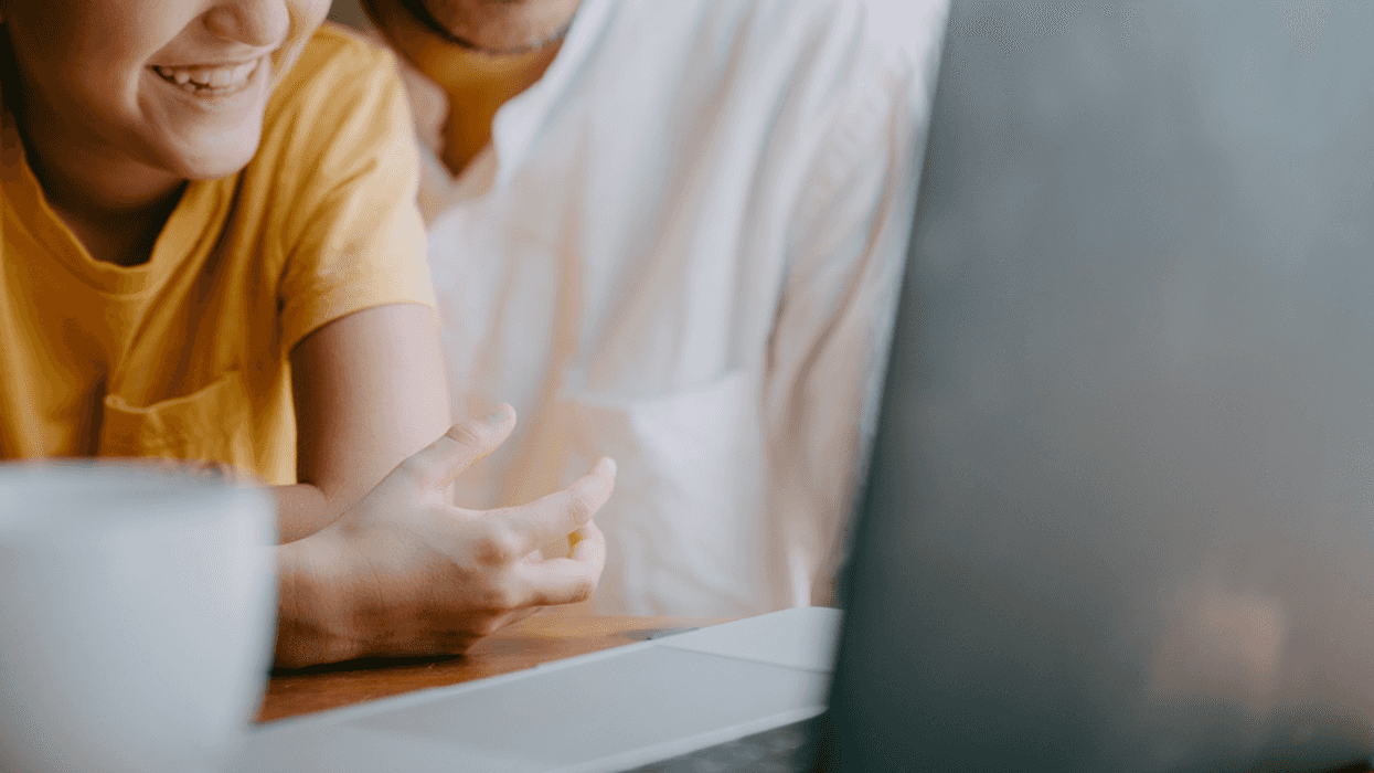 Father and daughter FaceTiming on computer.