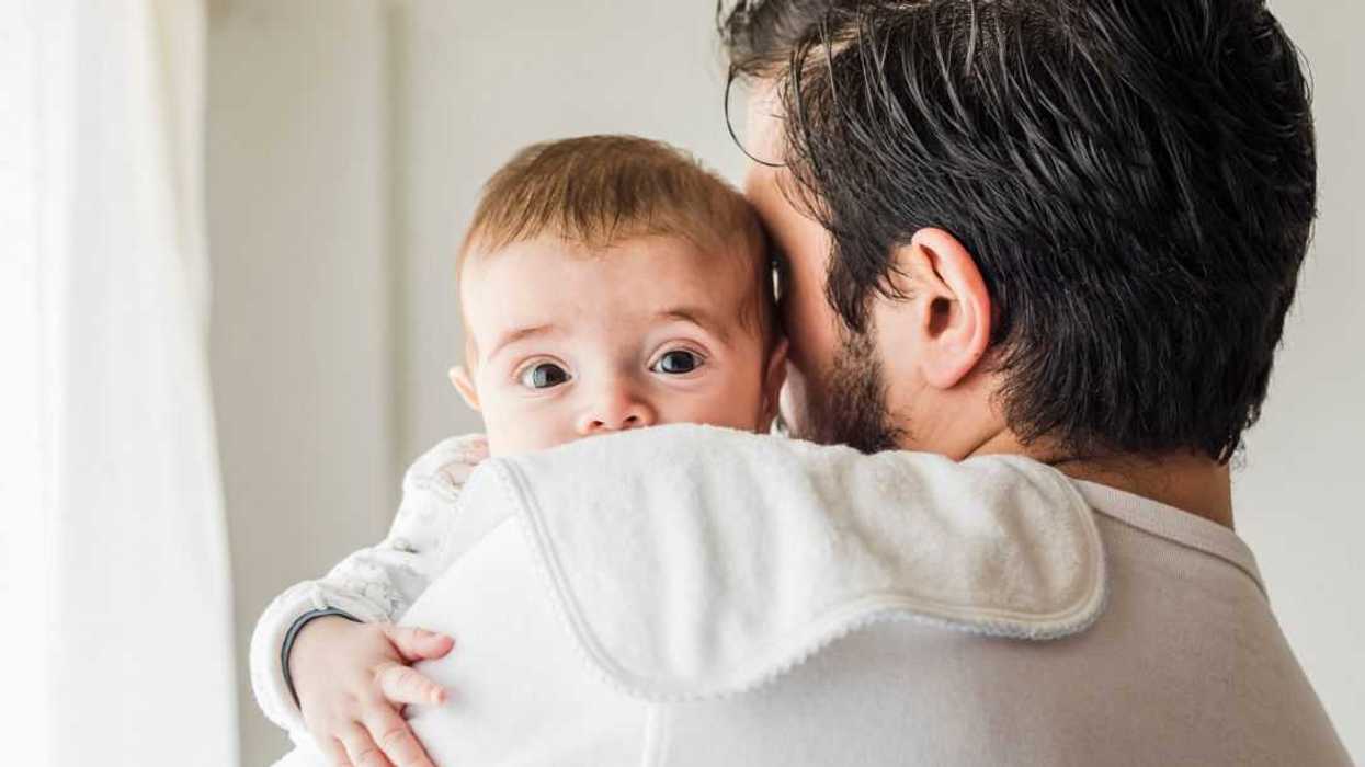 Father burping his baby.