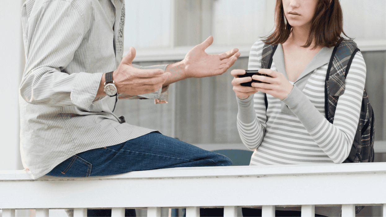 Father having discussion with teen daughter