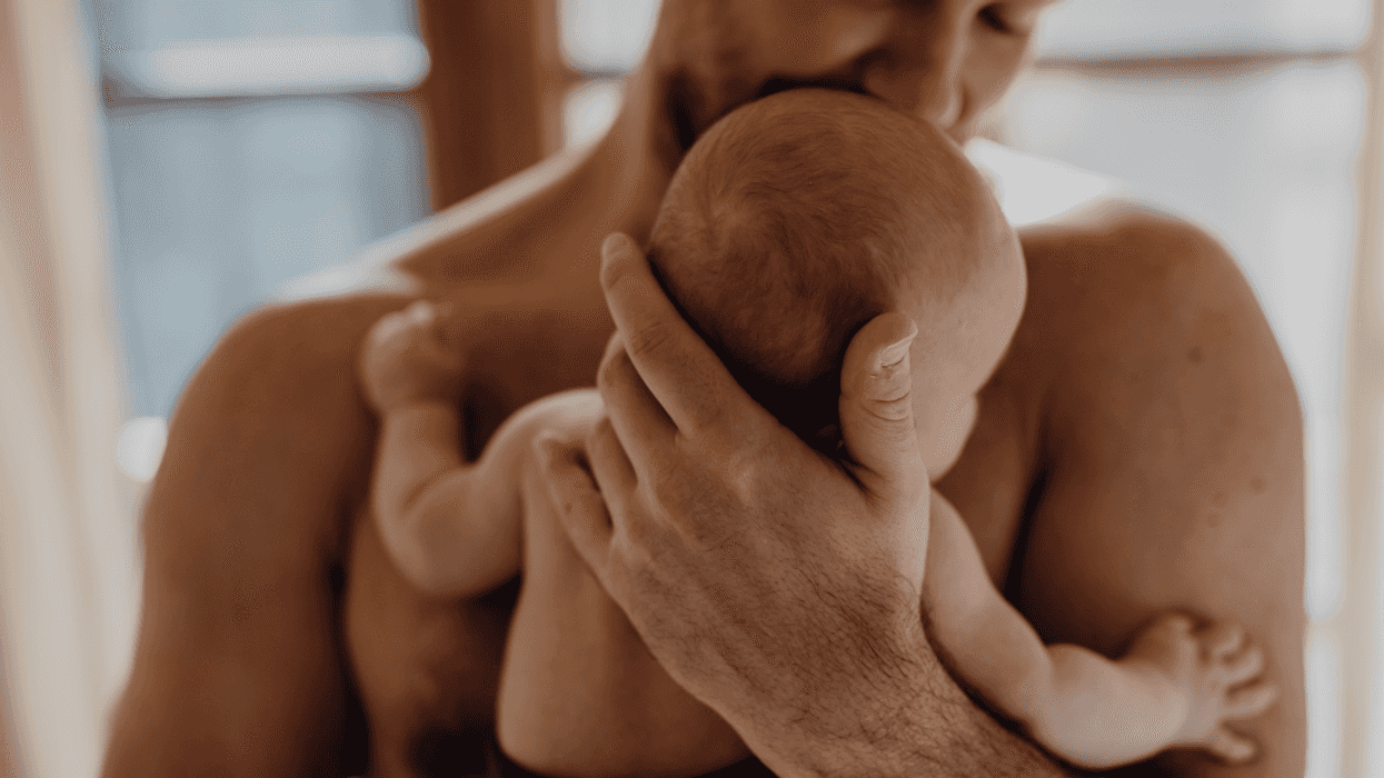 father holding an infant