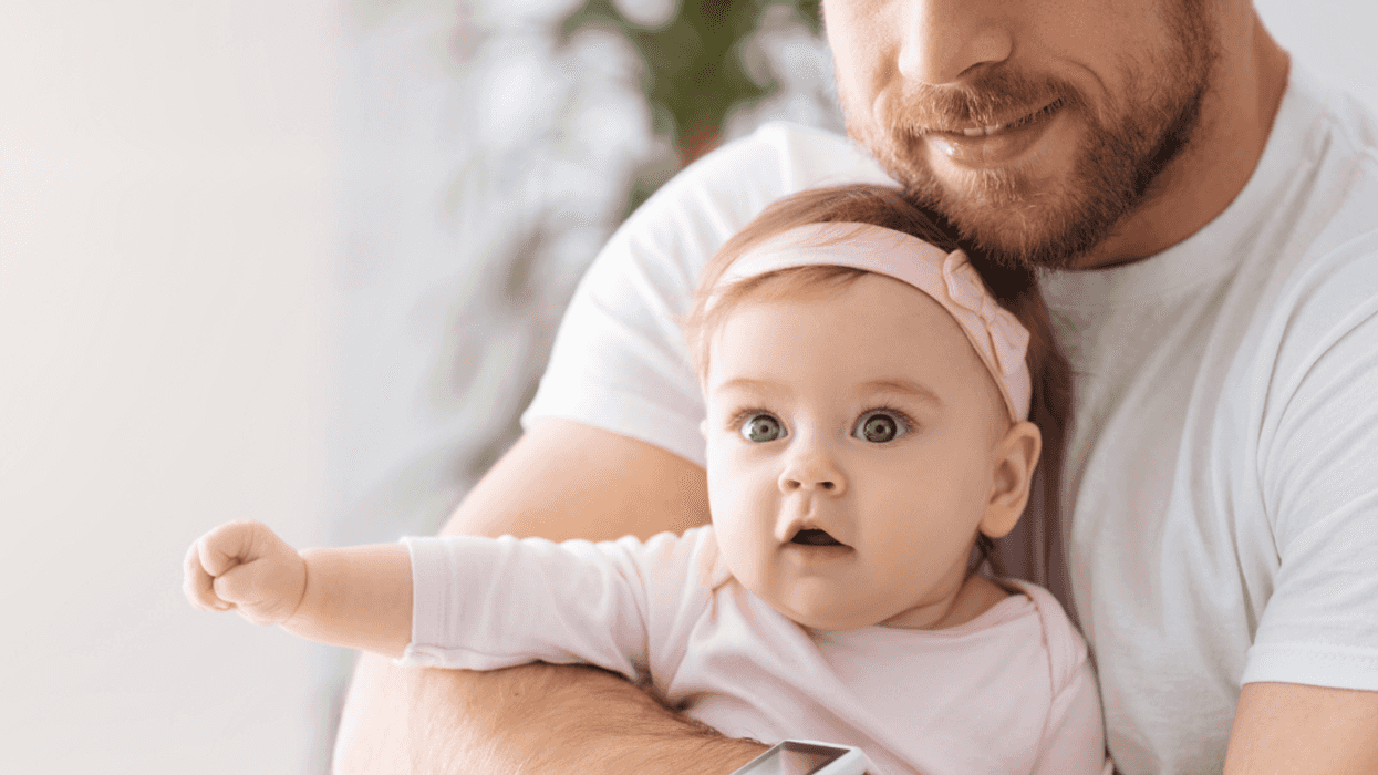 father holding infant