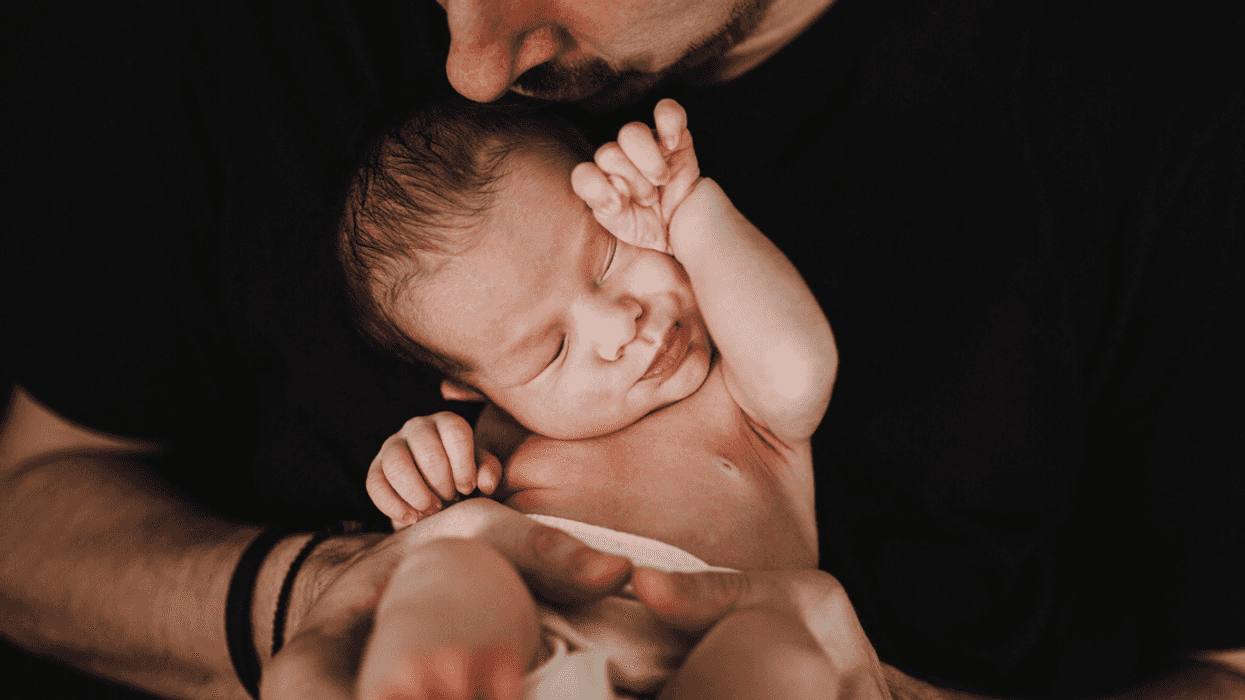 father holding infant