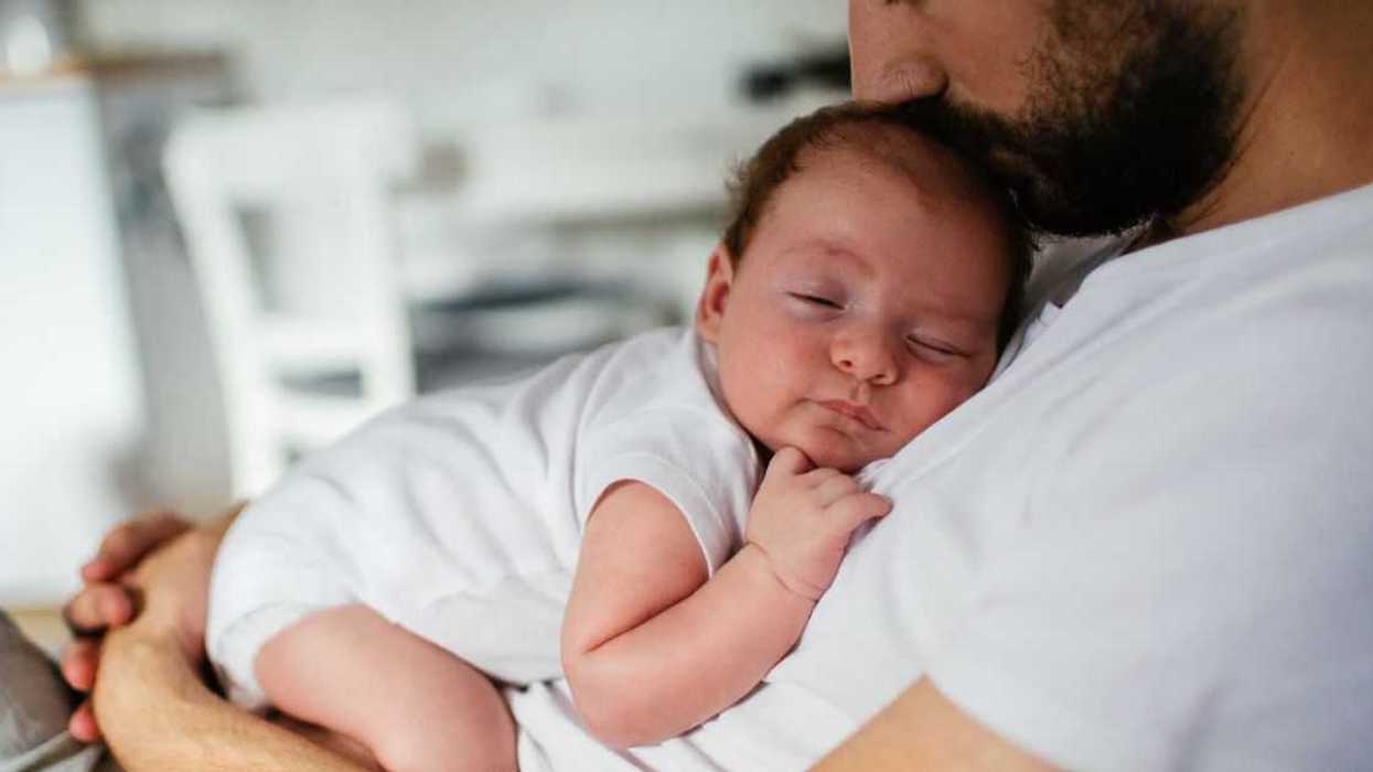 Father holding sleeping infant
