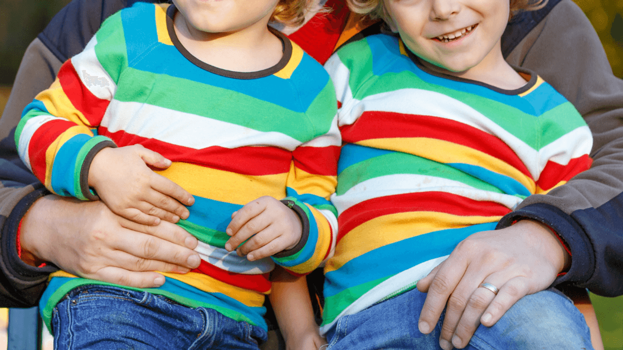 father holding twins