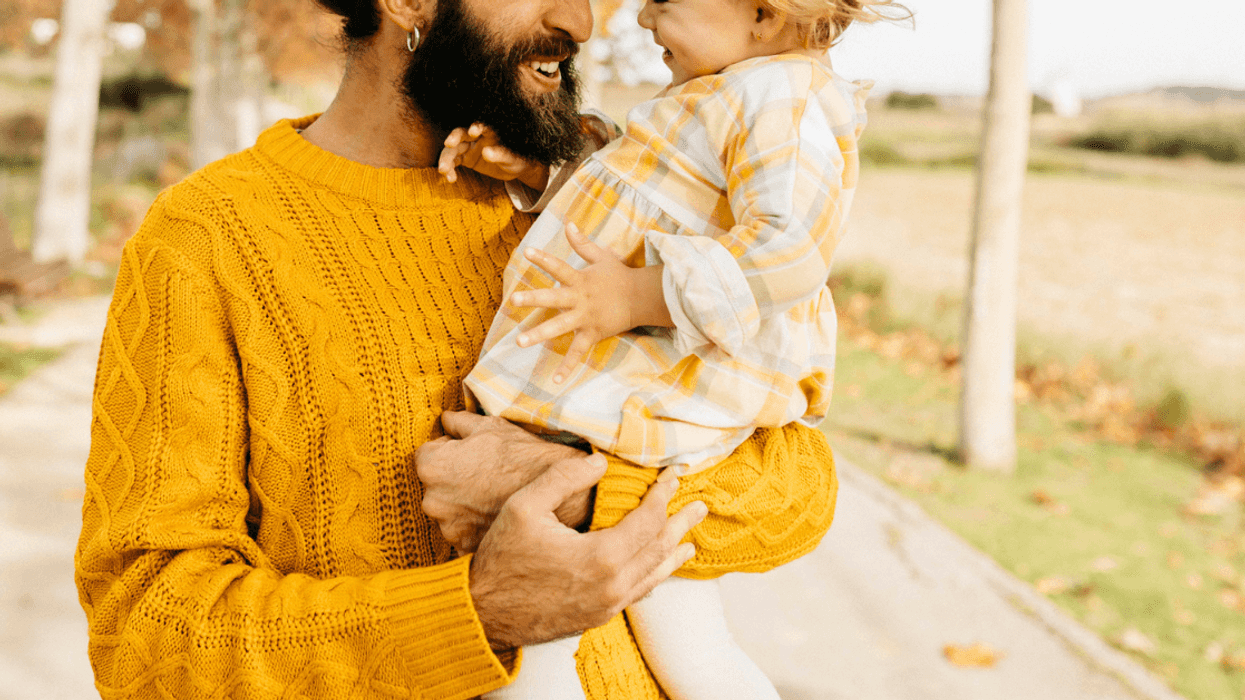 Father joyfully holding young daughter