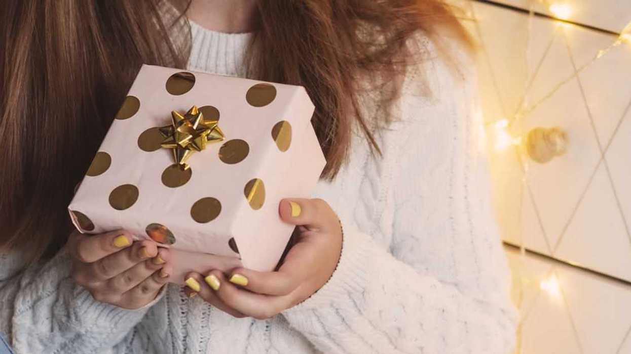 Female hands holding gift box. Christmas, New year, birthday concept.