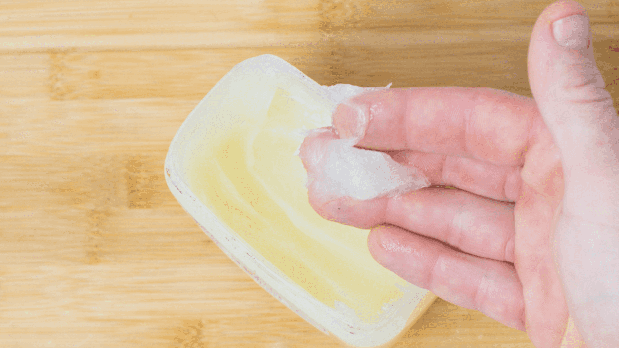 fingers scooping petroleum jelly