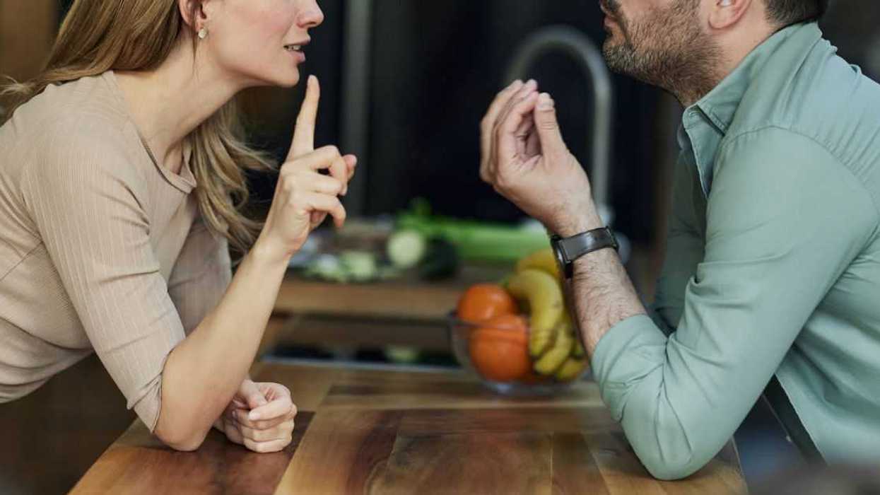Frustrated couple having an argument in the kitchen.