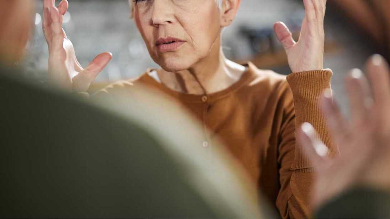 Frustrated mature woman arguing with her husband at home.