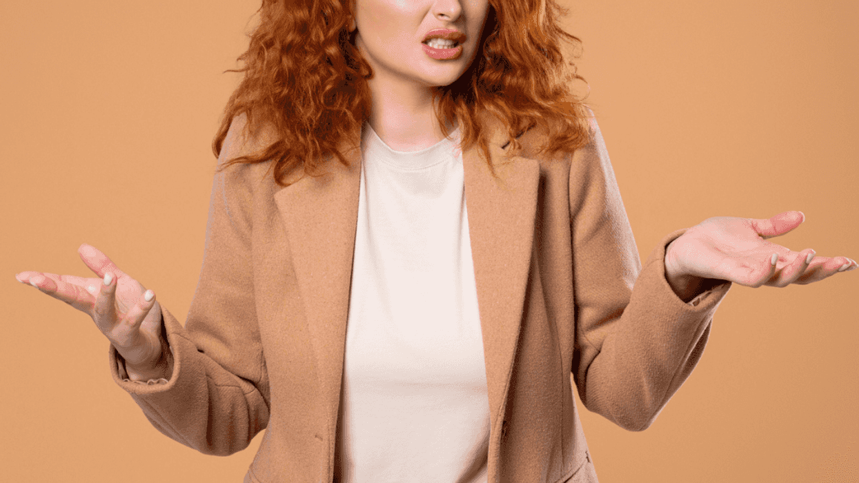 Frustrated woman shrugging her shoulders