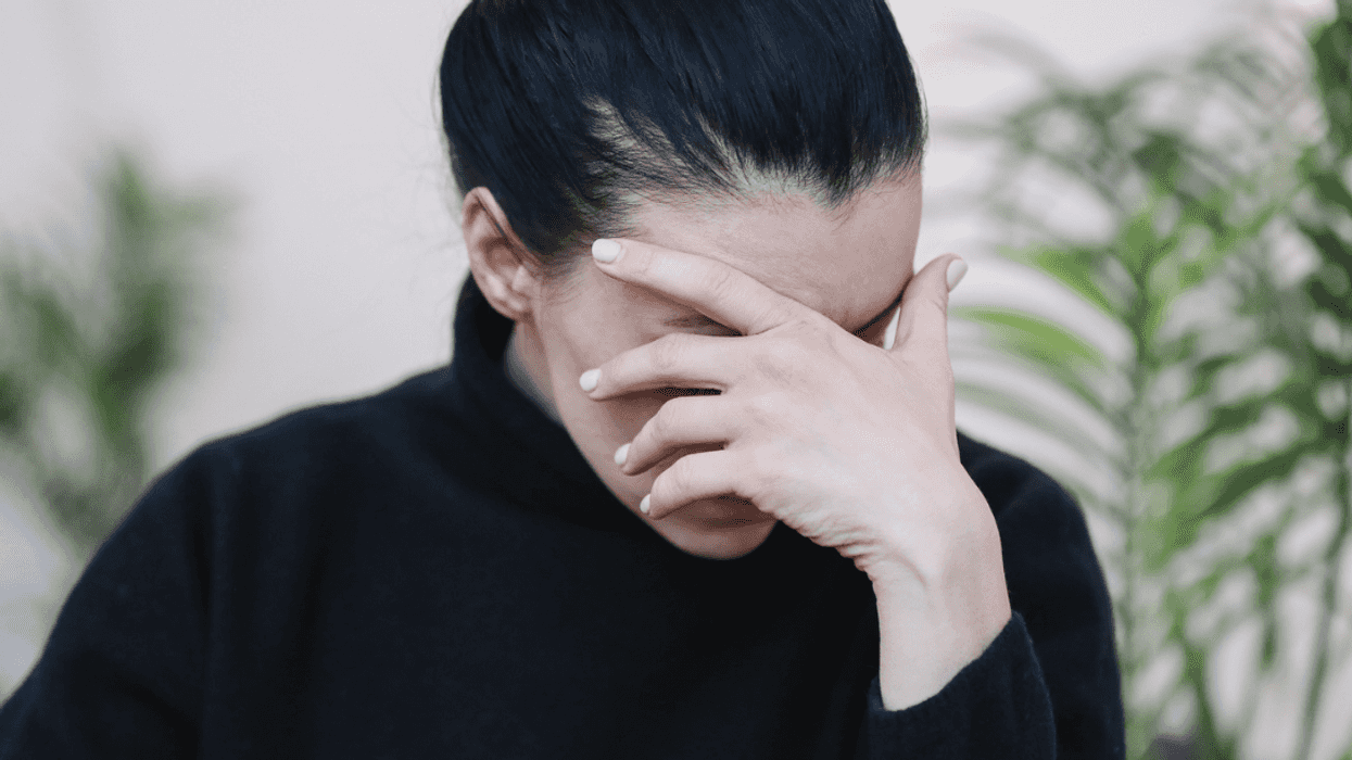 Frustrated woman with her hand covering her face