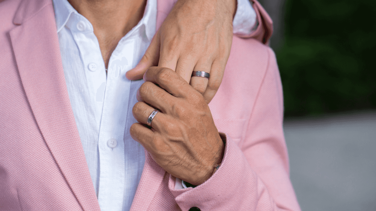Gay couple wearing wedding rings