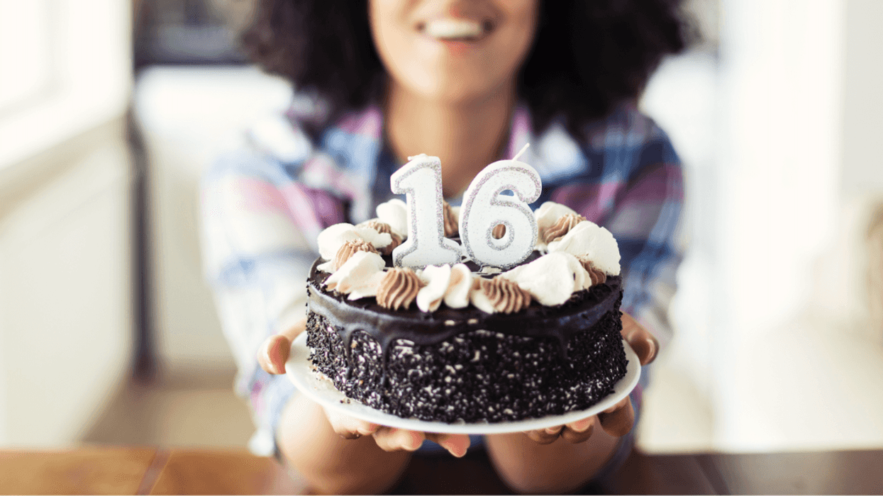 Girl blowing out candles on sweet 16 cake.