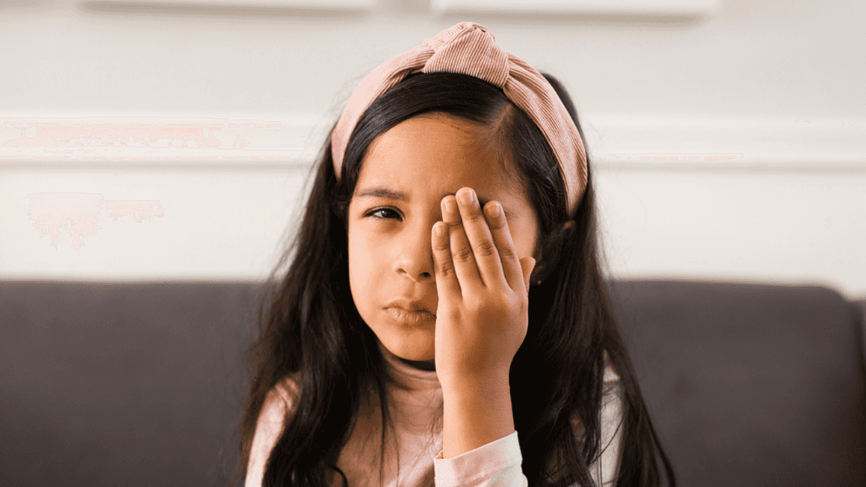 Girl covering her eye