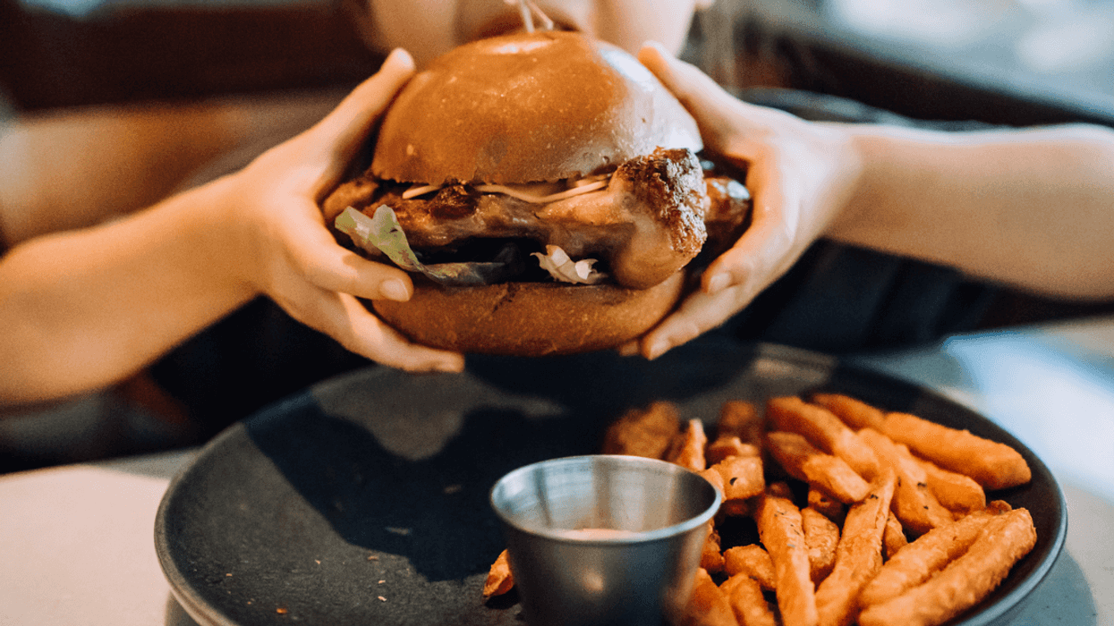 Girl eating meat sandwich