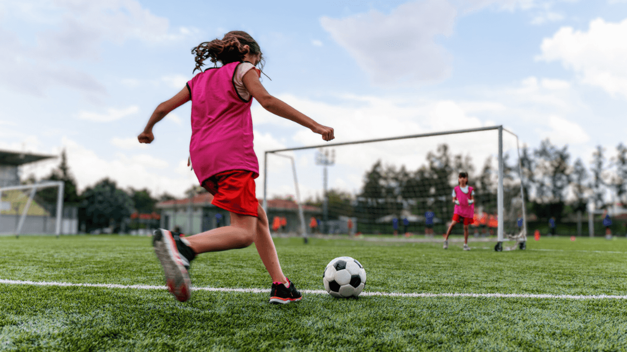 girl practicing soccer