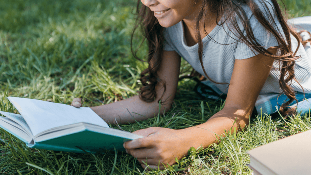 Girl reading a book outside