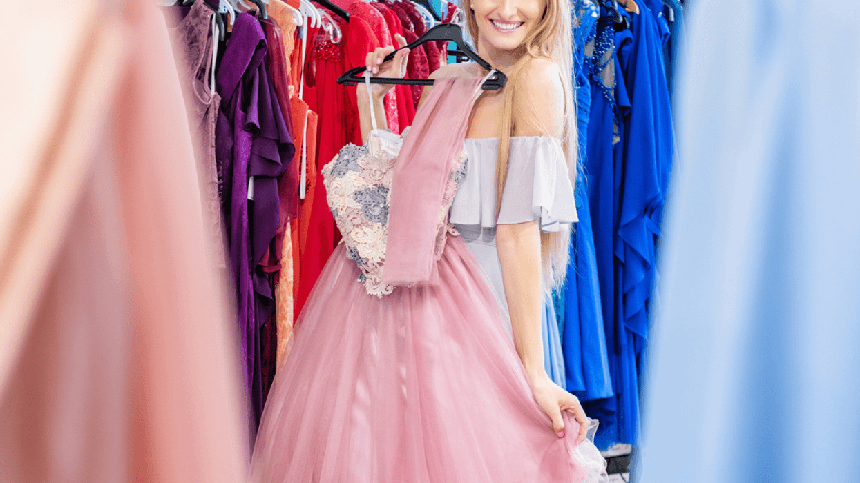 Girl trying on prom dresses