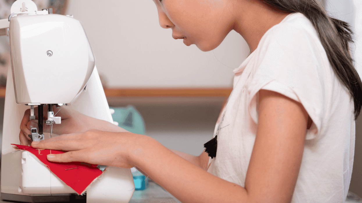Girl using sewing machine