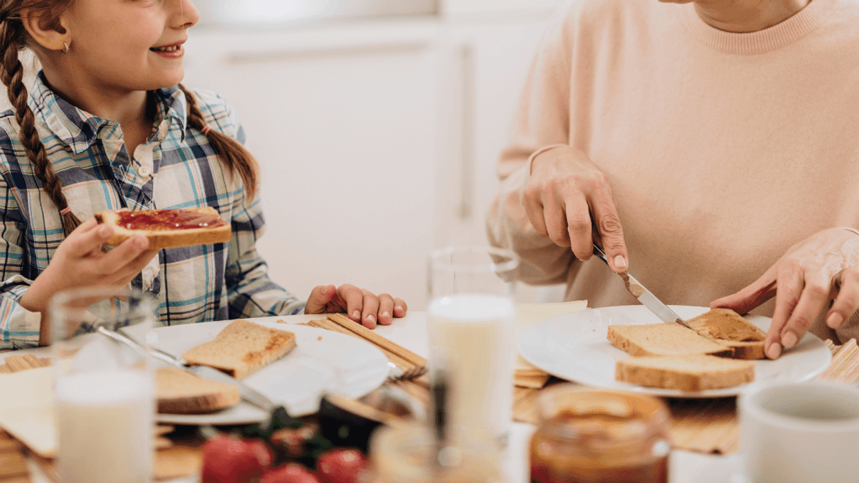 grandmother and granddaughter eating toast