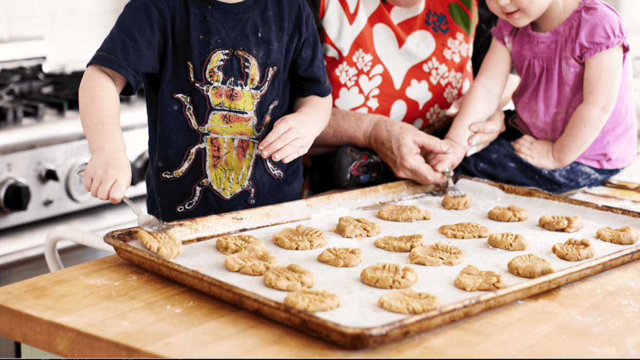 Grandmother baking cookies with grandchildren.