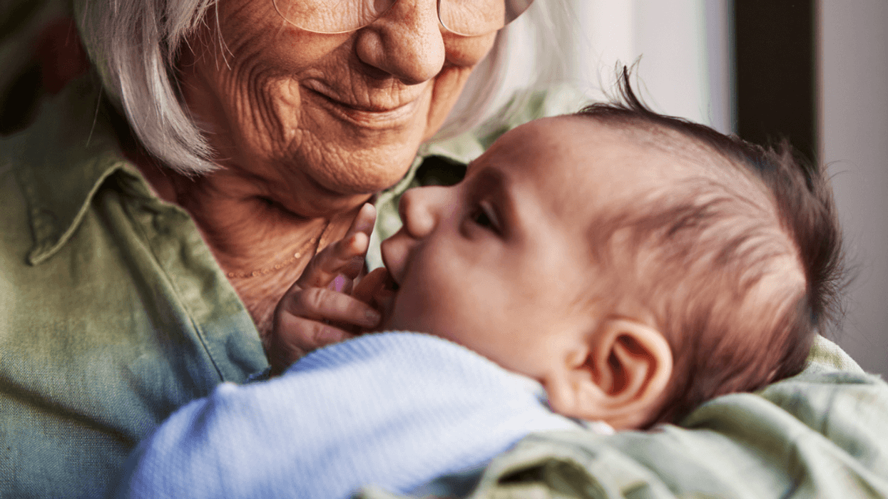 Grandmother holding her newborn grandchild