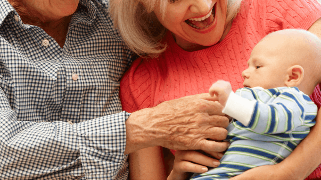 grandparents holding baby