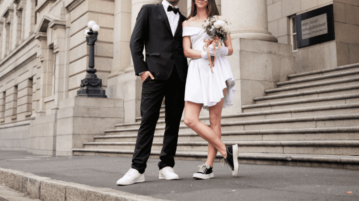 groom and bride in front of courthouse