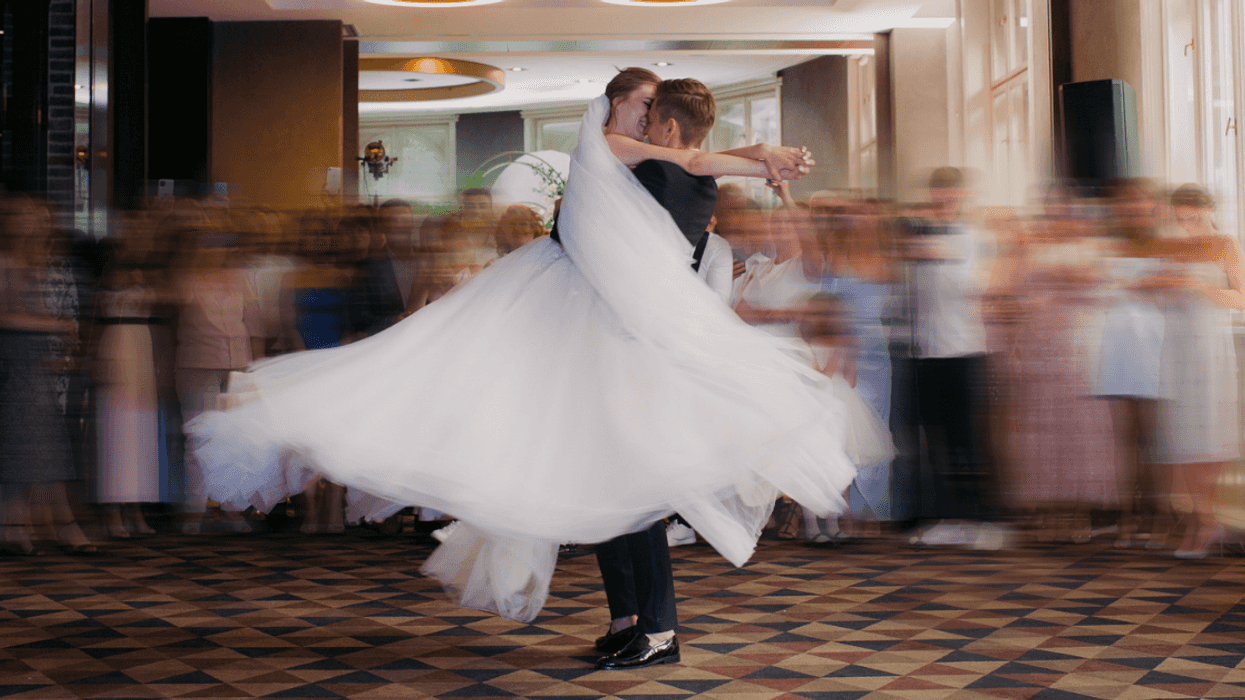 groom spinning his bride in the air
