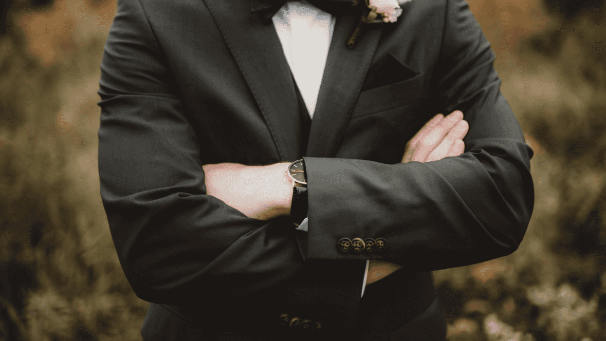 Groom with his arms crossed
