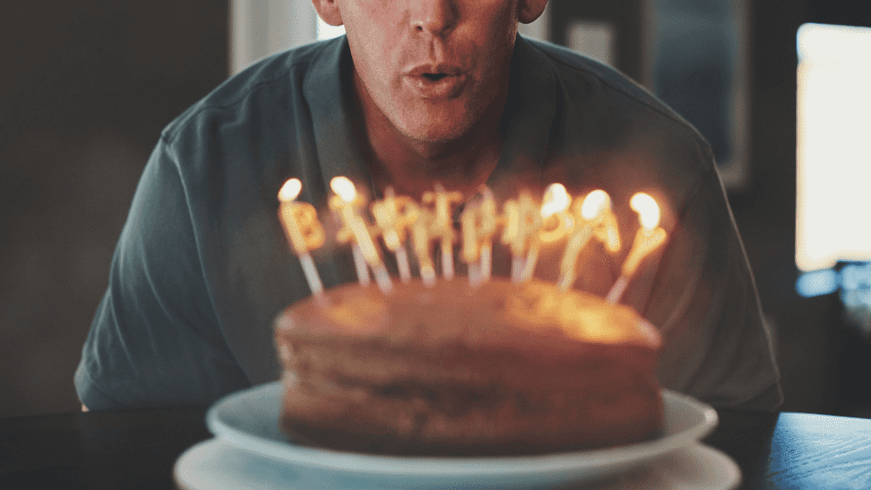 Guy blowing out his birthday candles