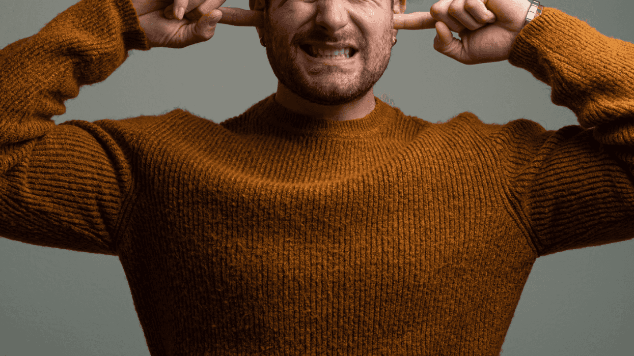 Guy covering his ears