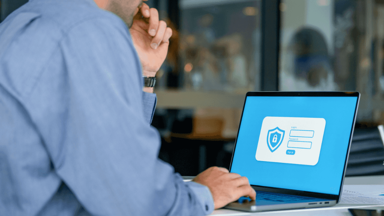 Guy entering password on computer to work