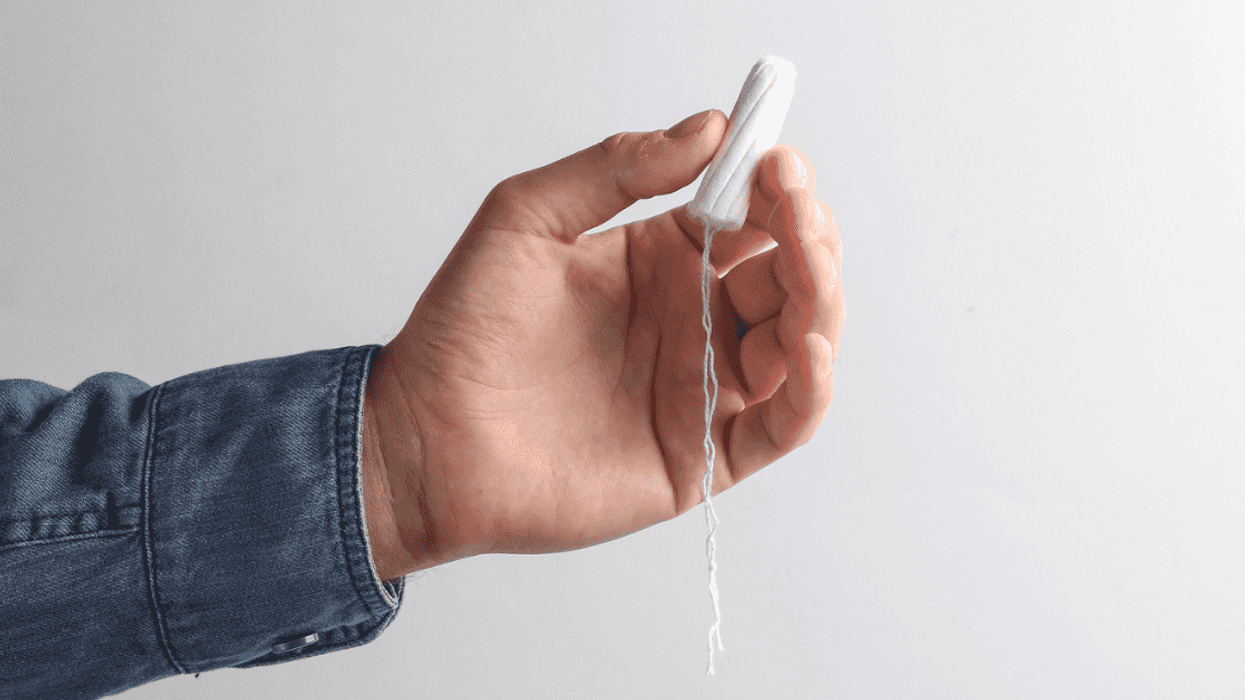 Guy holding a tampon