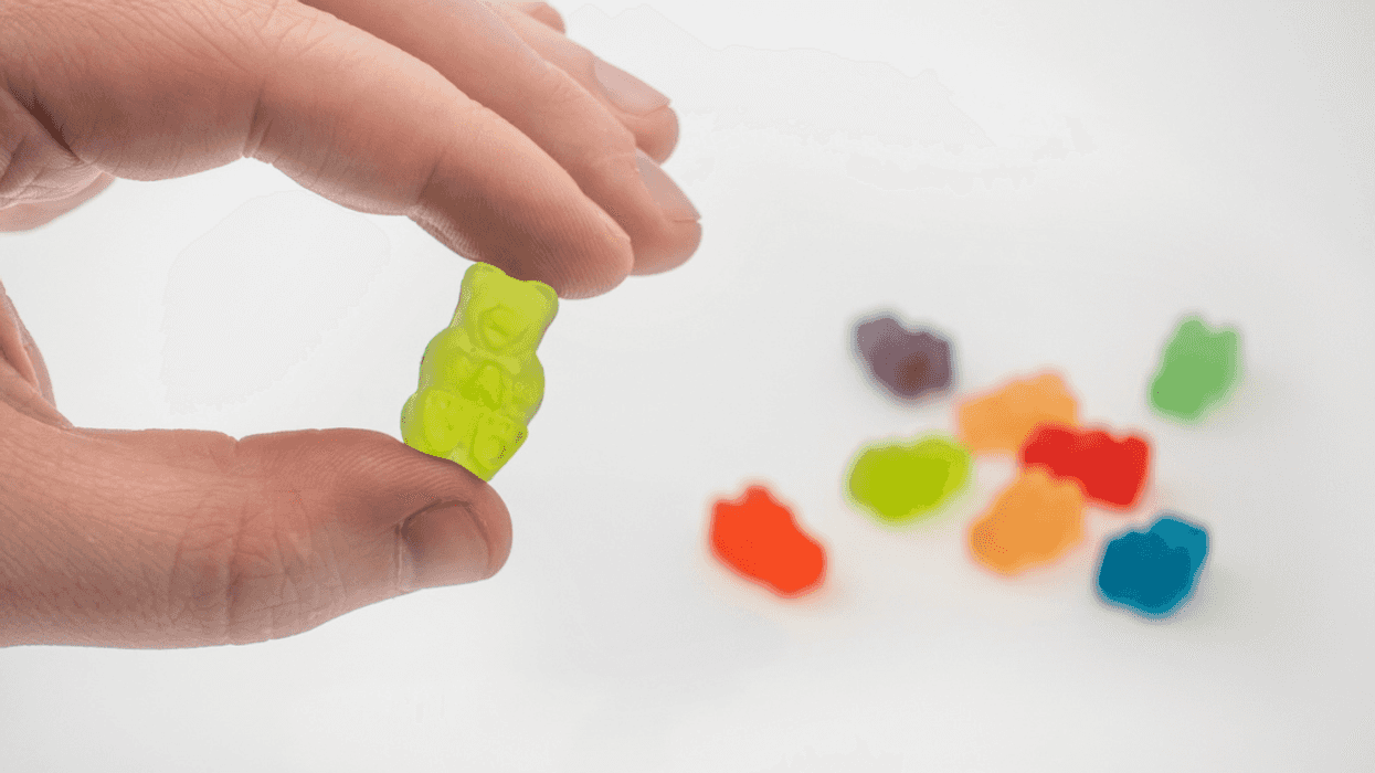 Guy holding up THC gummies