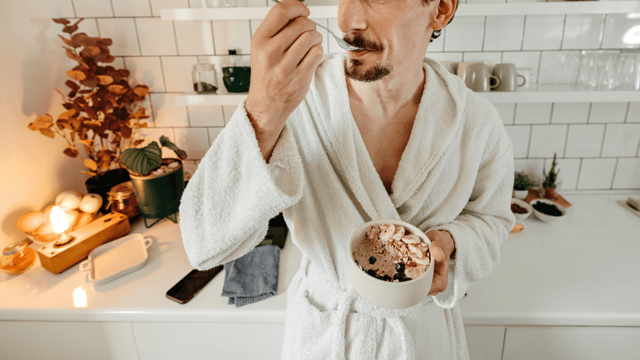 Guy in a robe eating