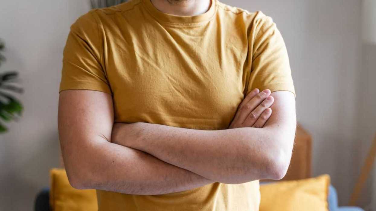 Guy in a yellow t-shirt crossing arms