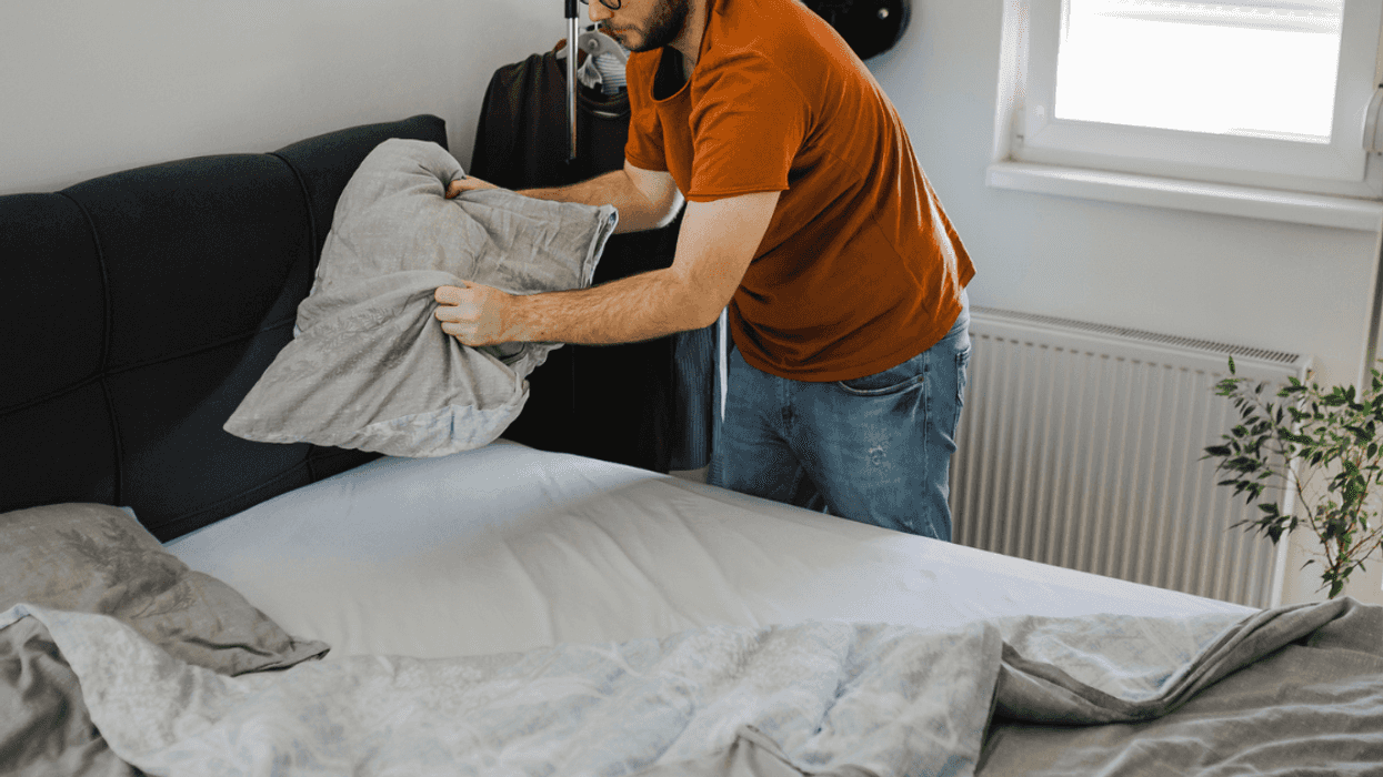 Guy making the bed