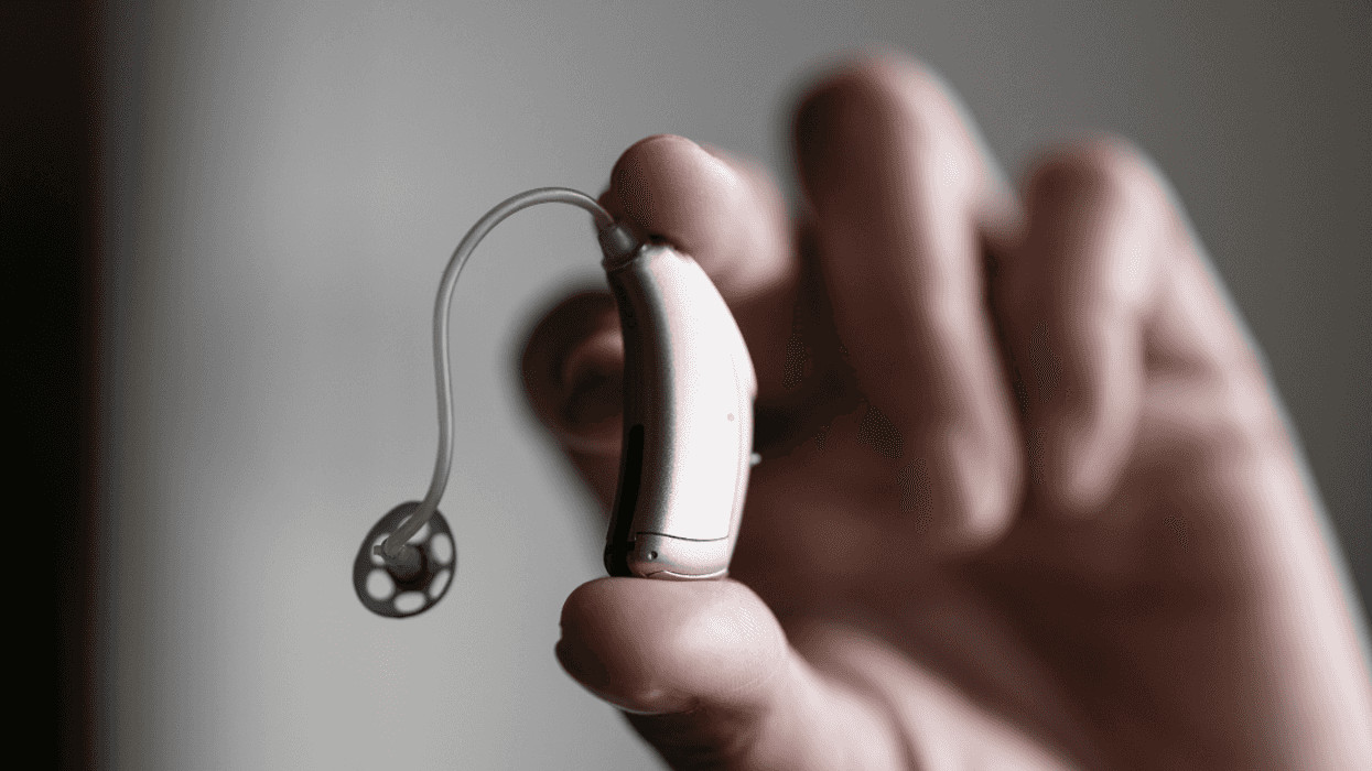 hand holding hearing aid