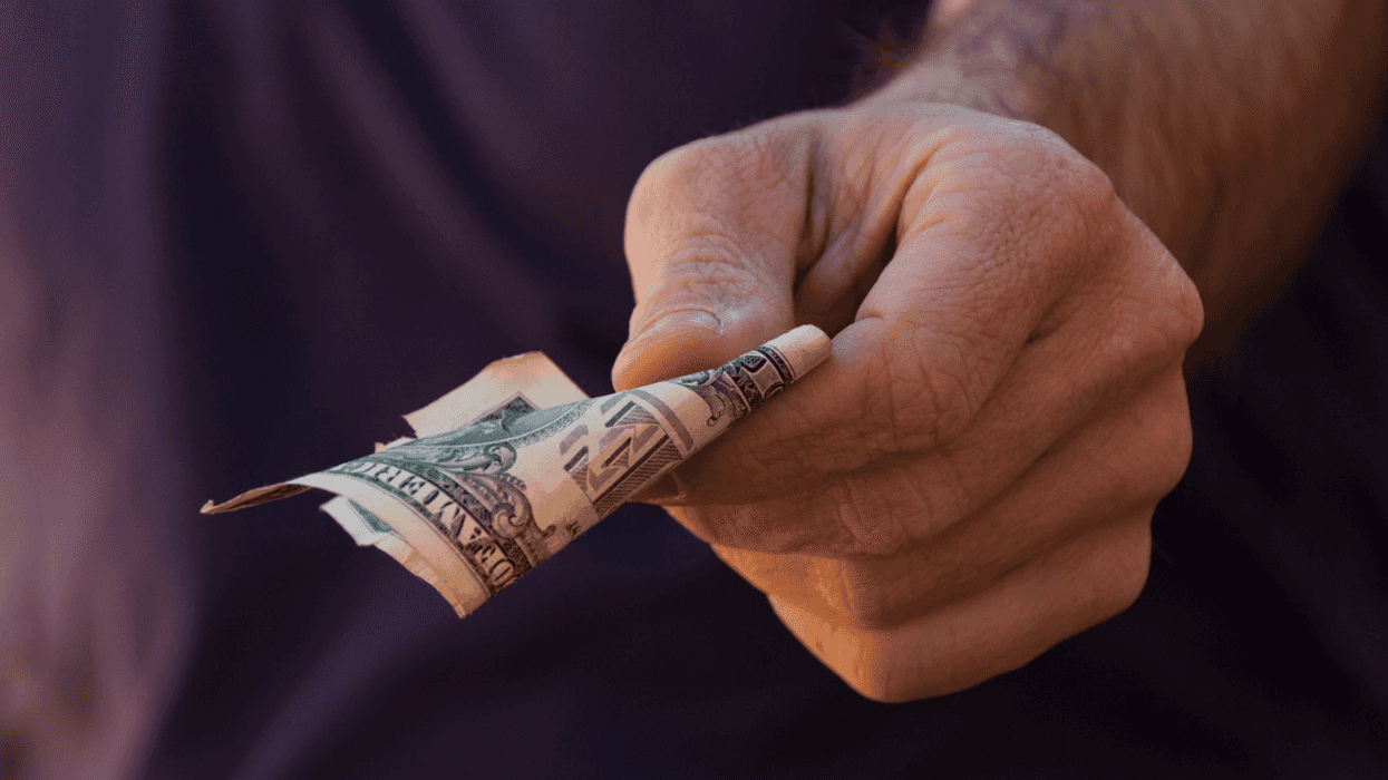 hand holding United States 1 dollar bill