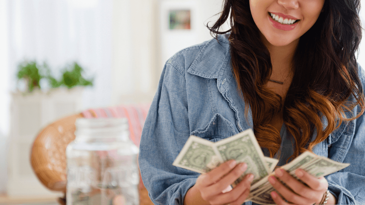 Happy woman counting money