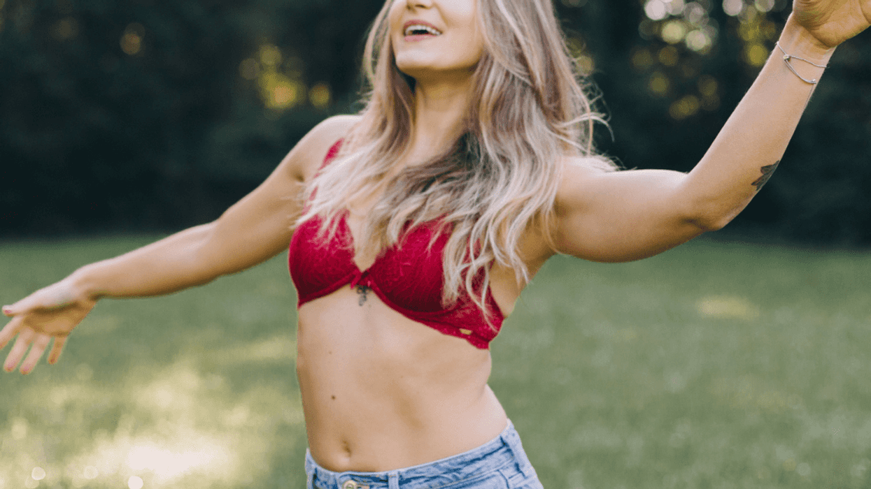 Happy woman in bra outside