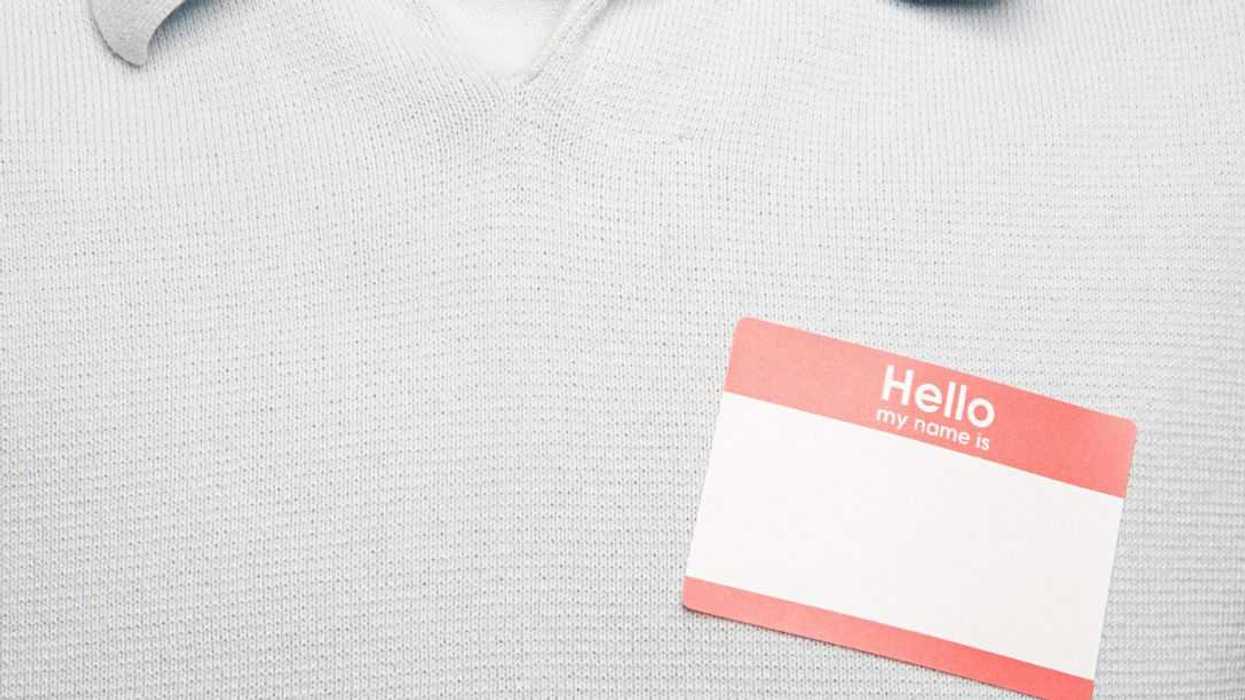 Headless shot of a man with blank name tag.